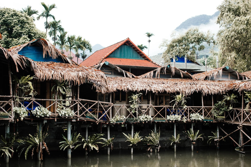 Houses on Stilts Over the Body of Water